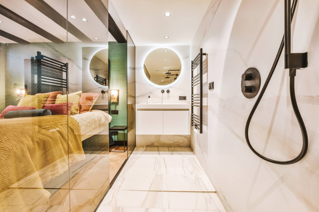 narrow-bathroom-with-glass-wall-near-bedroom-2023-11-27-05-03-37-utc.jpg